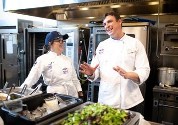 Culinary students laughing with one another