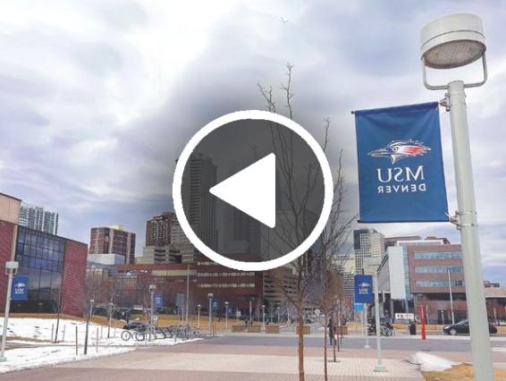 Photo of an MSU Denver banner with campus behind it and the play button in the foreground