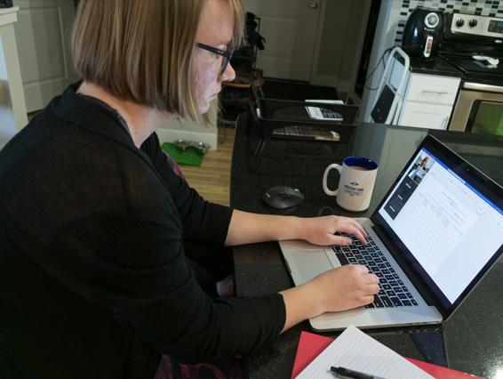 Student working at their computer in their kitchen