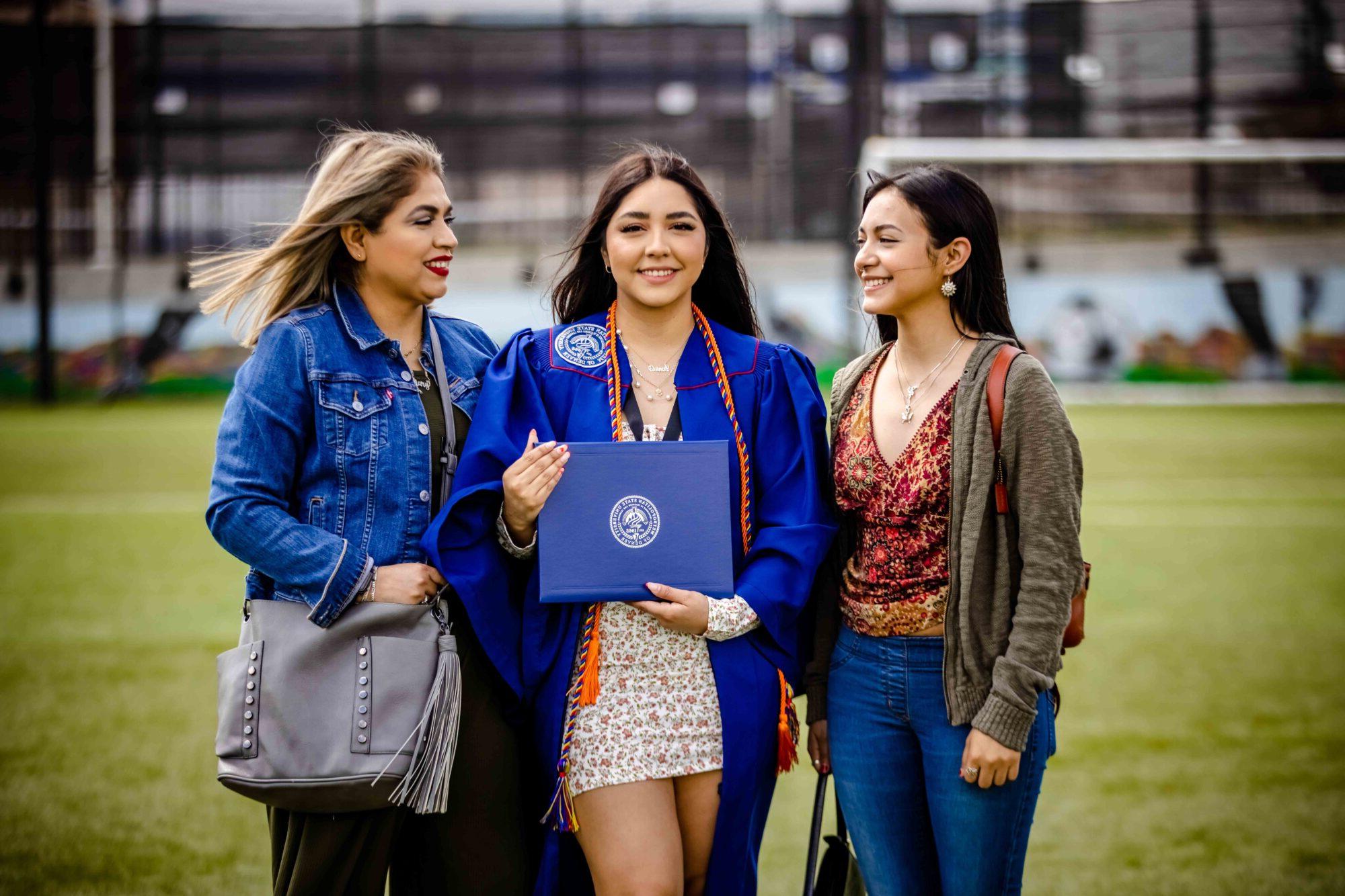 Graduate standing with their family after the ceremony