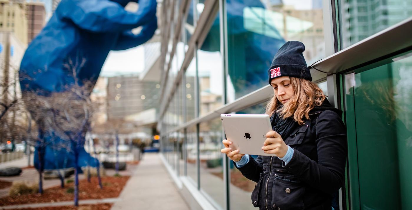 MSU Denver student with ipad near conference center downtown