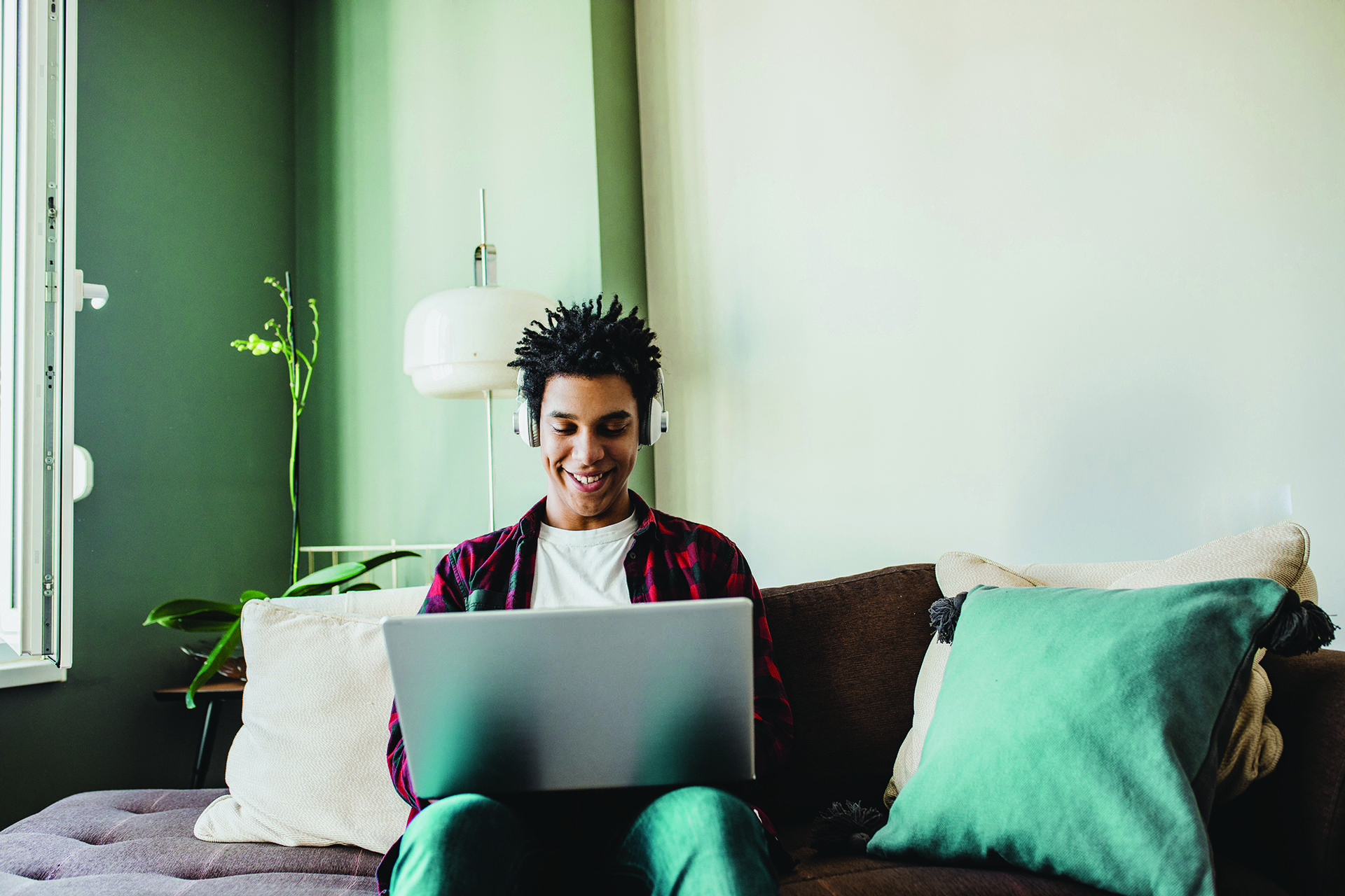 Student using his laptop at home