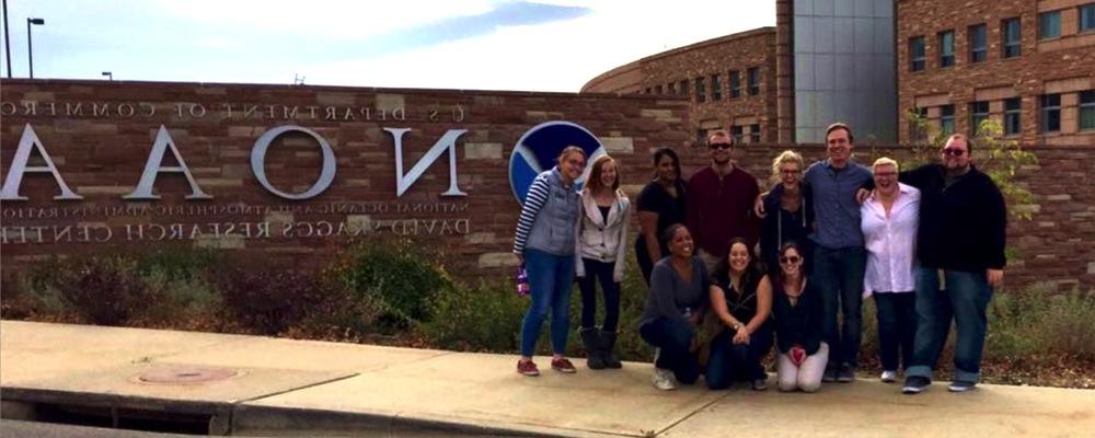 Students in front of the NWS sign