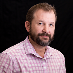 Profile image of Dr. Aaron Richmond, Professor. Solid black background.