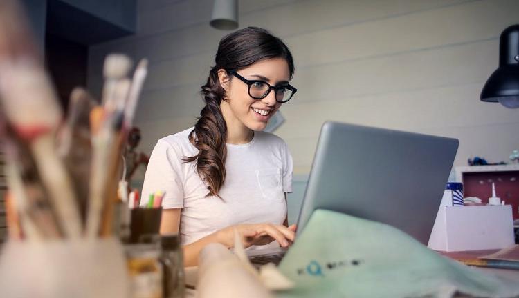 A woman working at a computer Photo by Andrea Piacquadio from Pexels.