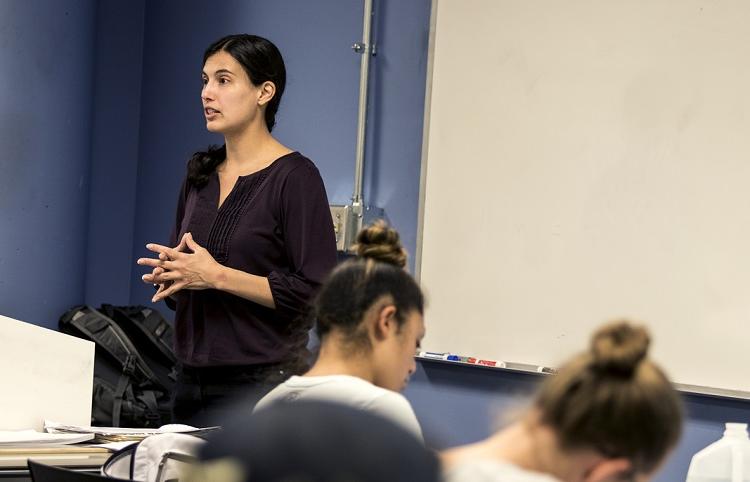 Emily Ragan, Ph.D., teaching in front of class.