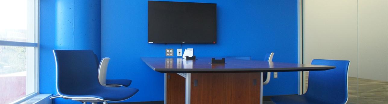 Blue study room with desk and chairs