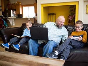 Father helping his kids with their homework.