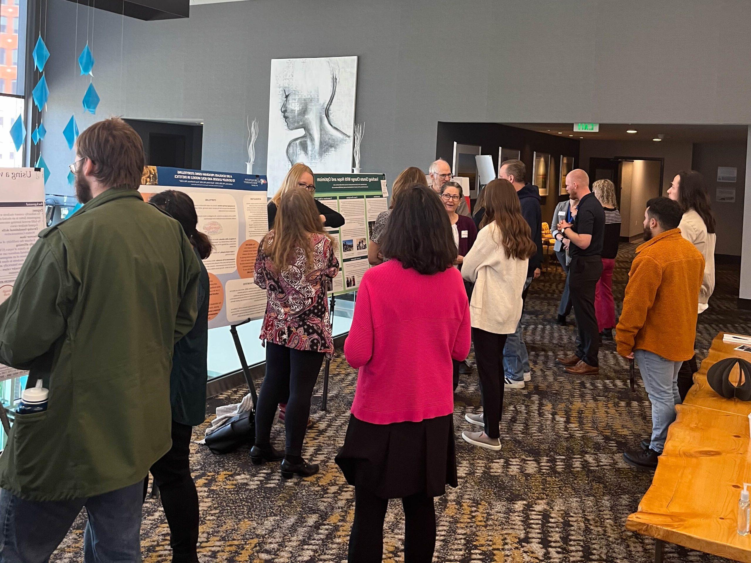 Faculty and staff discussing research projects at the SoTL poster session