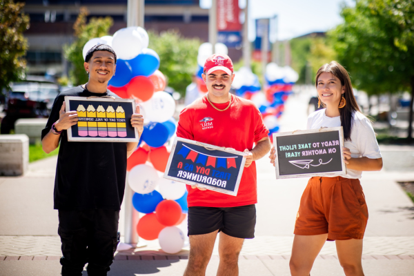 MSU Denver students holding up fall semester signs