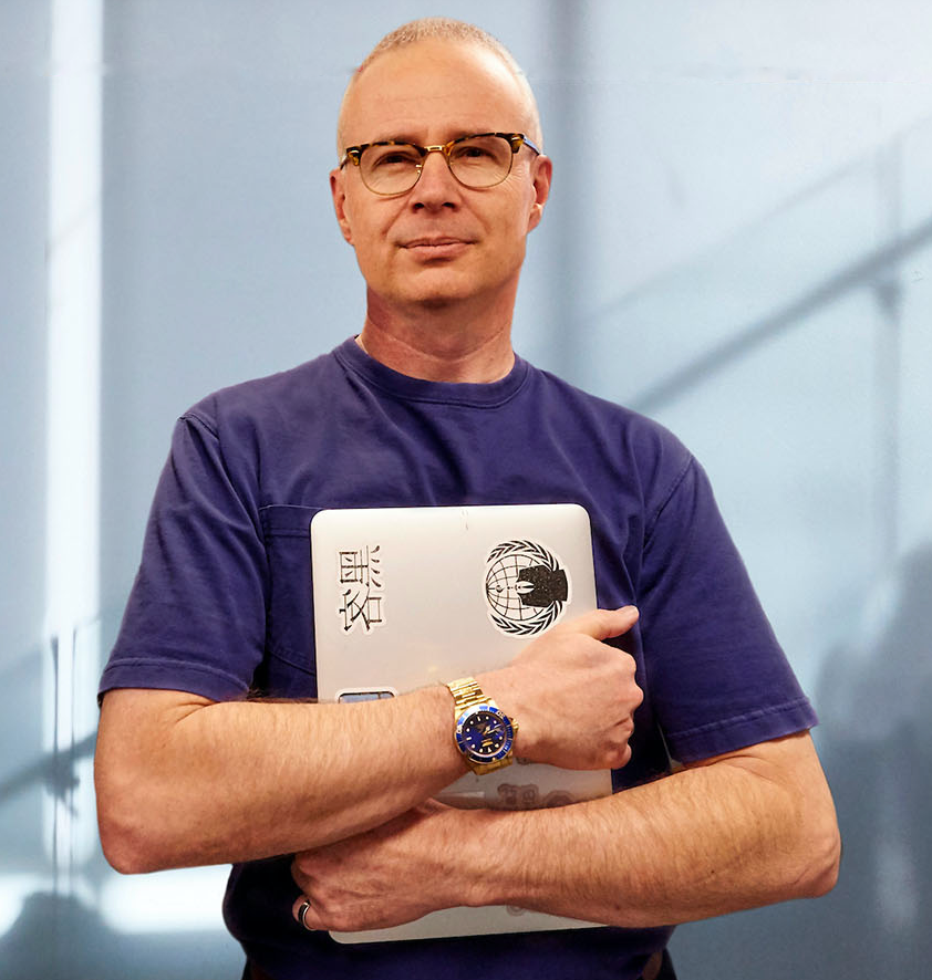 College of Aerospace, Computing, Engineering, and Design Interim Dean, Steve Beaty headshot with laptop in hands