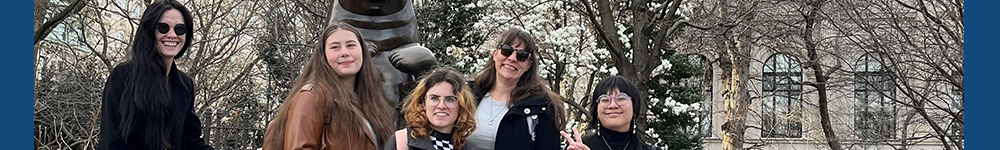 MSU Denver students smiling with a bear stature and trees in the background