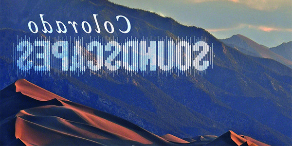 Sand dunes against mountain backdrop at sunset with text 