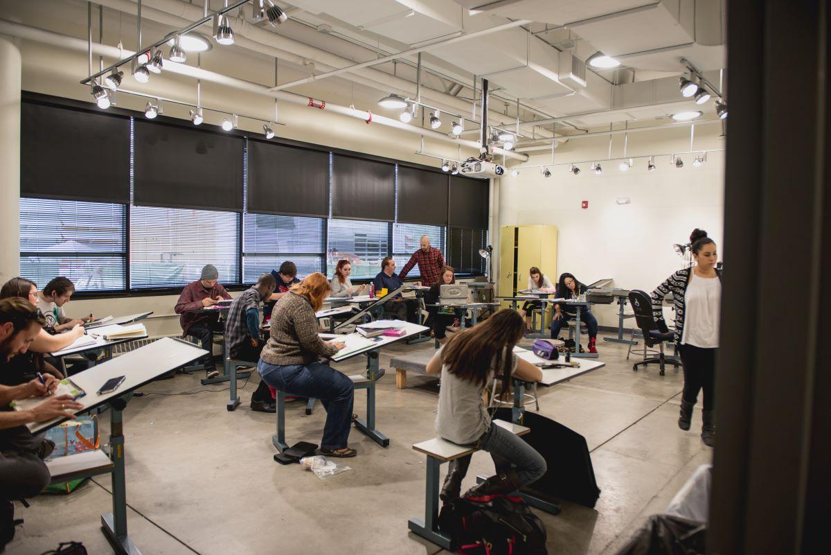 Students in a classroom drawing individually on easels