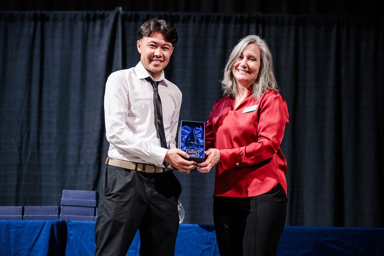 Mohammad Ahmadi poses for a photo with the award presenter for his 2024 Outstanding Student Leader of the Year award